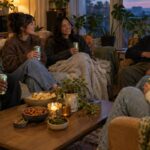 Young adults enjoying cannabis beverages together in a cozy living room setting