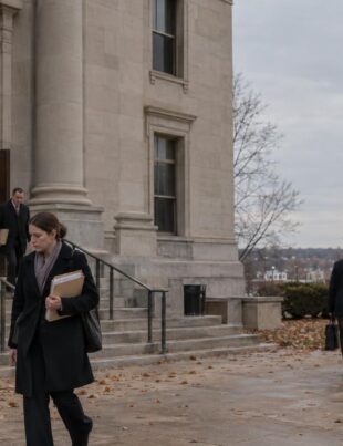 Nebraska courthouse exterior with people carrying legal papers in autumn