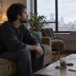Did ScHoolboy Q quit weed after smoking 20 times? Man sitting contemplatively in living room with cannabis jar on table